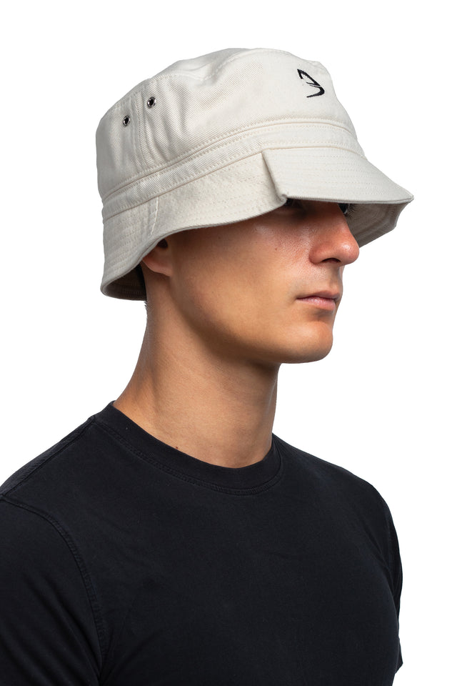 Three quarter front view of tapered bucket hat in bone colorway on model.