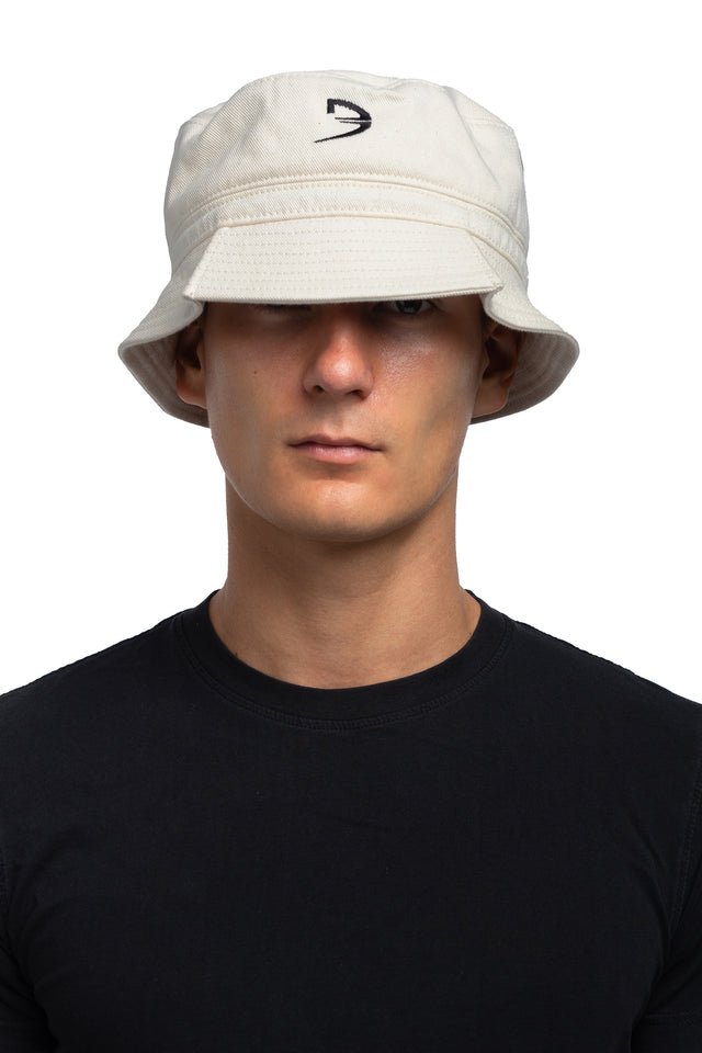 Front view of tapered bucket hat in bone colorway on model.