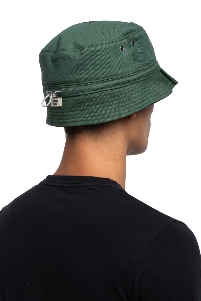 Three quarter back view of tapered bucket hat in evergreen colorway on model.