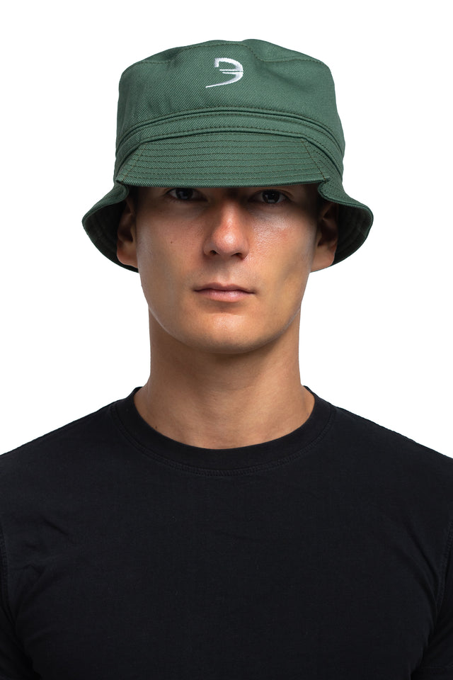 Front view of tapered bucket hat in evergreen colorway on model.