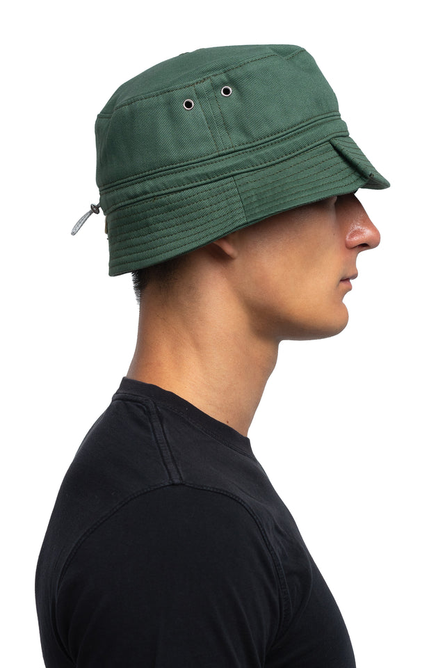 Side view of tapered bucket hat in evergreen colorway on model.