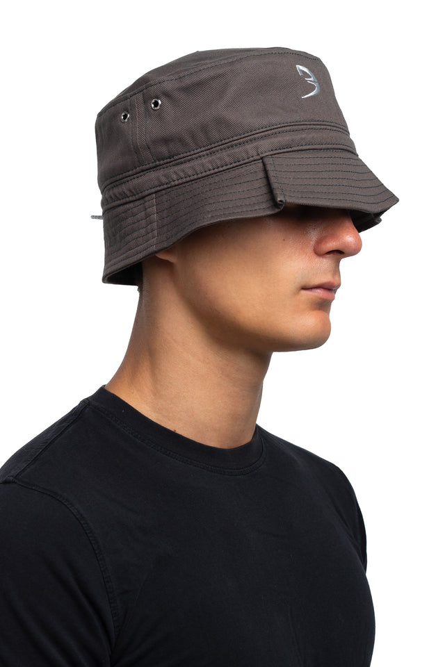 Three quarter front view of tapered bucket hat in graphite colorway on model.