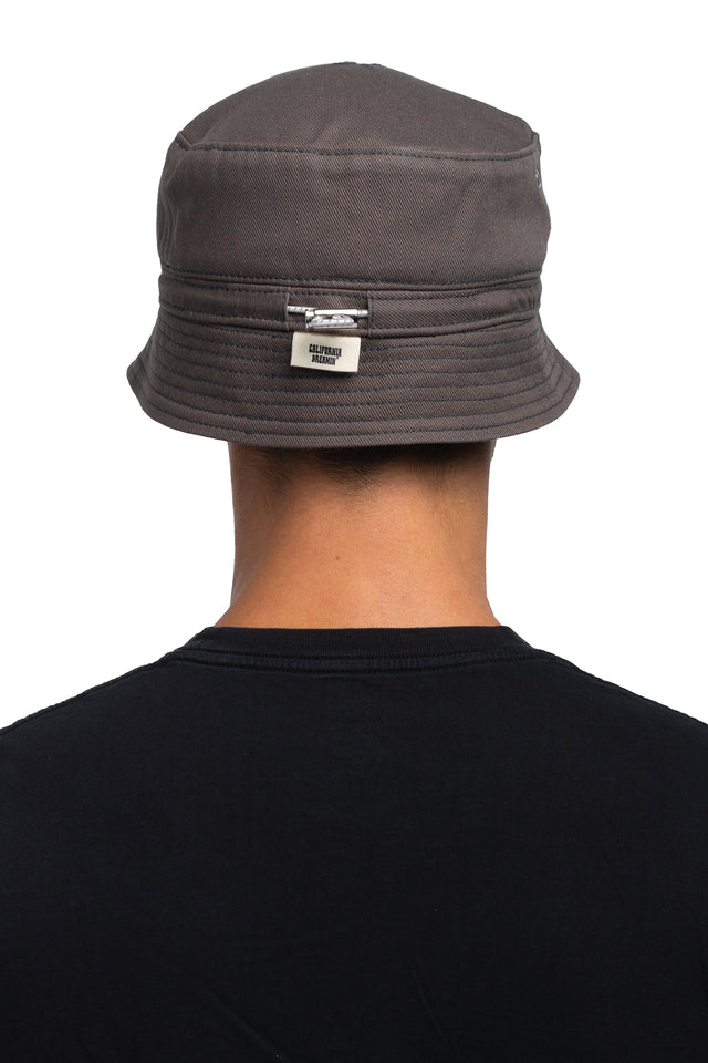 Back view of tapered bucket hat in graphite colorway on model.