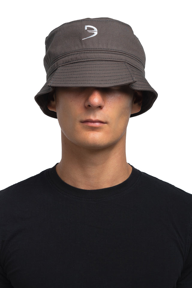 Front view of tapered bucket hat in graphite colorway on model.