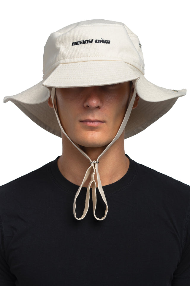 Front view of floppy bucket hat in bone/eggshell colorway worn on model with sides unsnapped in natural state.