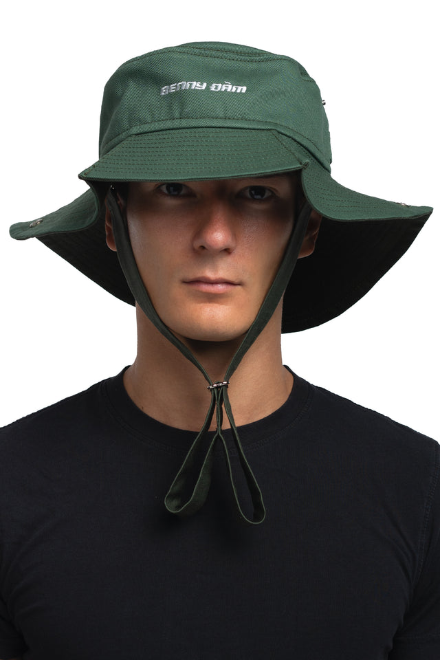 Front view of floppy bucket hat in evergreen/pine colorway worn on model with side of hat unsnapped in natural state.