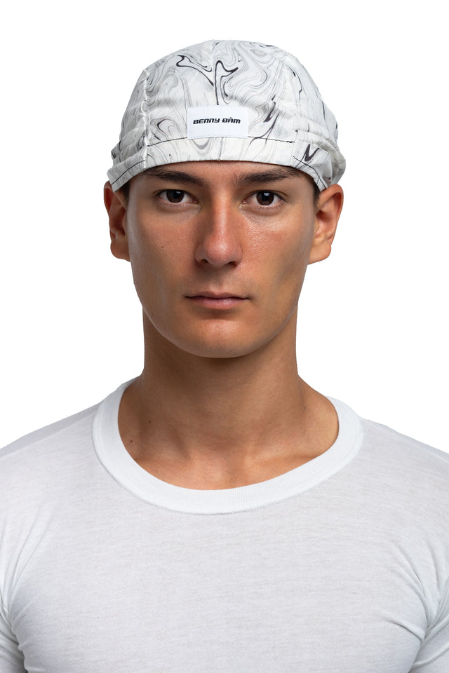 Front view of black & white colorway bandana hat worn on model.