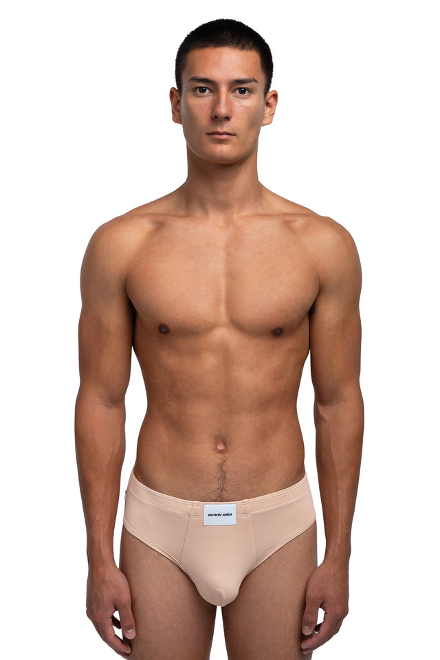 Front view of classic briefs underwear on model in desert peach colorway.