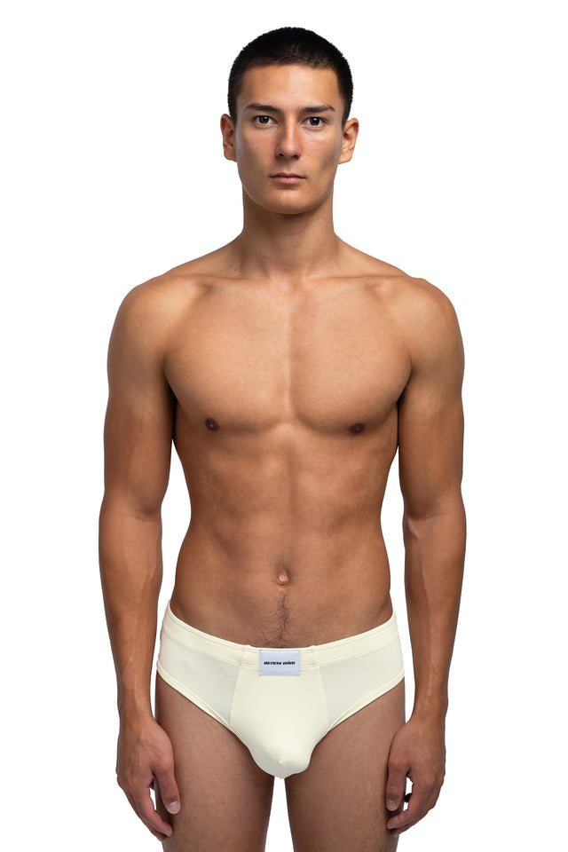 Front view of classic briefs underwear on model in eggshell colorway.