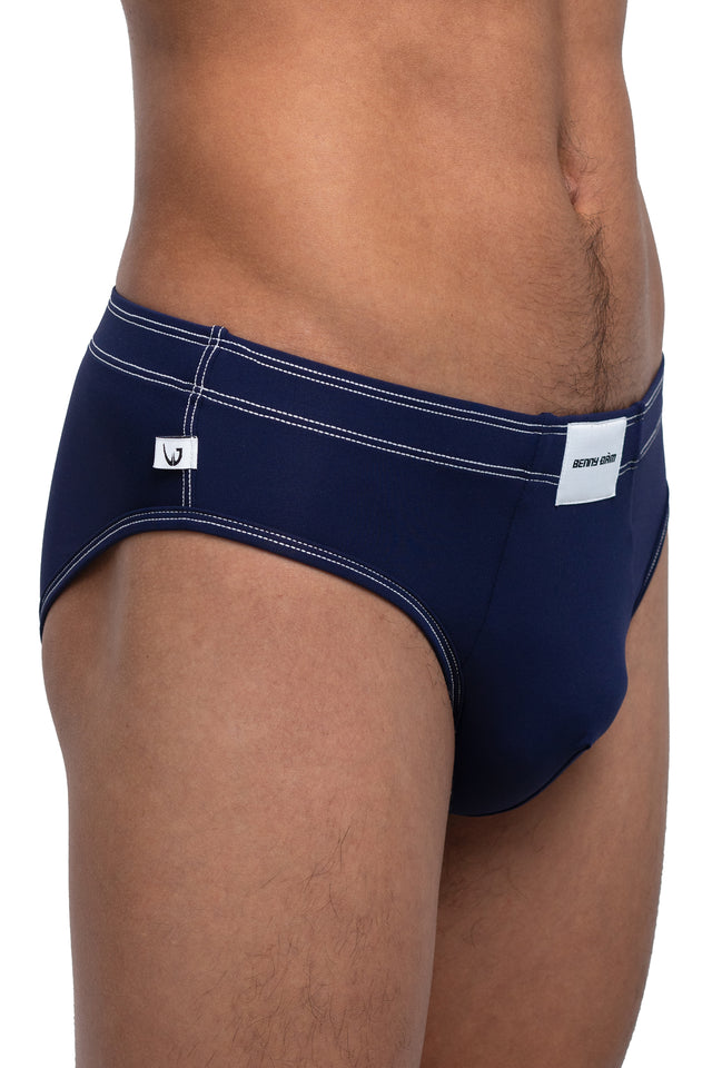 Three quarter front view of classic briefs underwear on model in midnight blue colorway. (Close up)