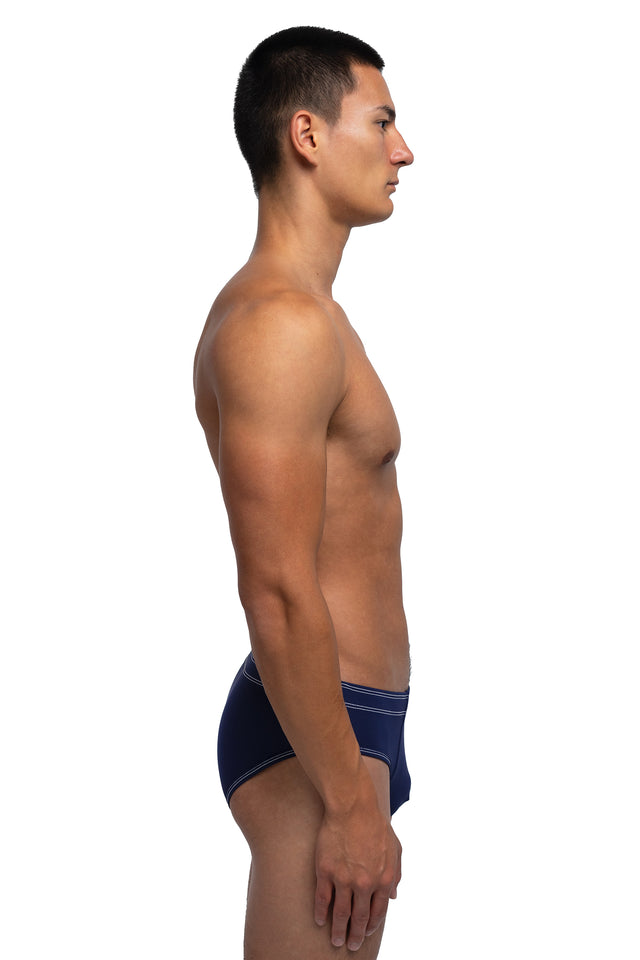 Side view of classic briefs underwear on model in midnight blue colorway.