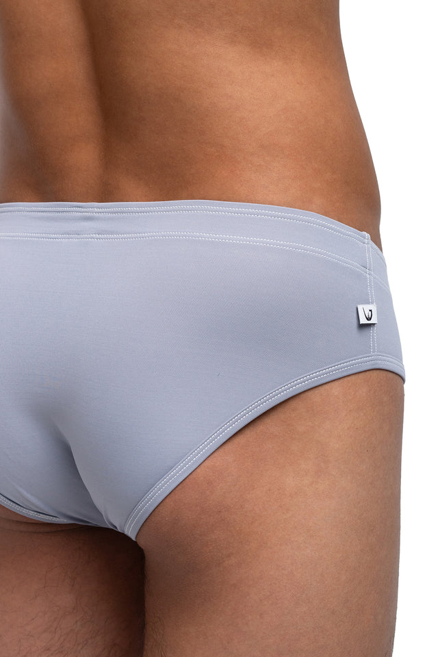 Three quarter back view of classic briefs underwear on model in slate colorway. (Close up)
