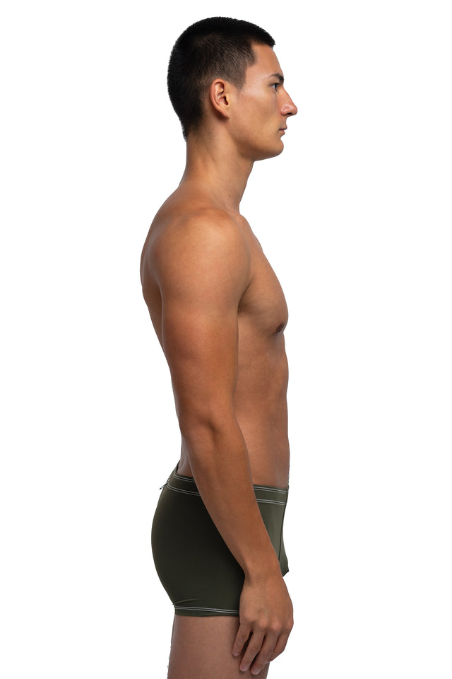 Side view of boxer briefs underwear on model in dark olive colorway.