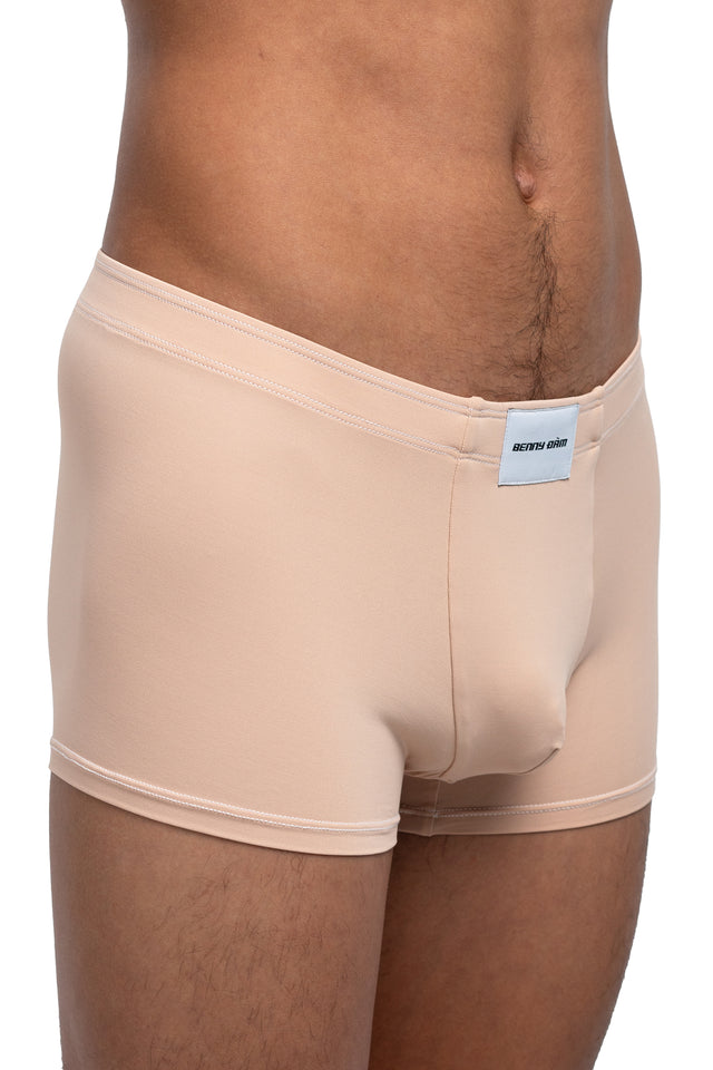 Three quarter front view of boxer briefs underwear on model in desert peach colorway. (Close up)