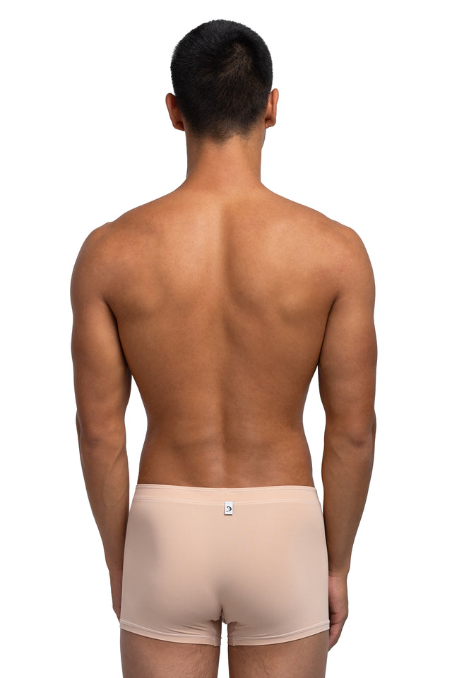Back view of boxer briefs underwear on model in desert peach colorway.