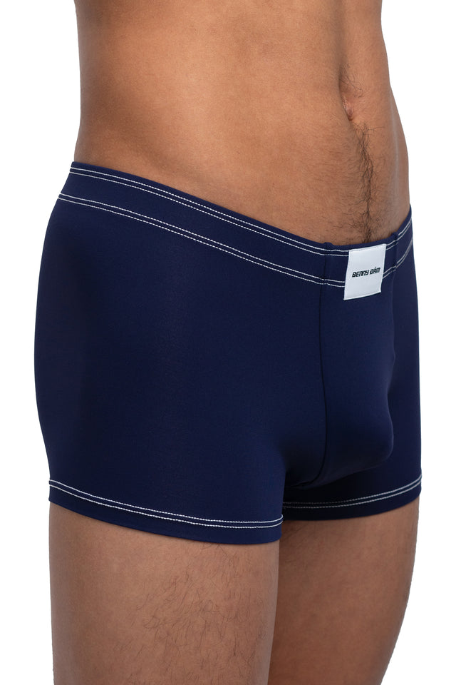 Three quarter front view of boxer briefs underwear on model in midnight blue colorway. (Close up)