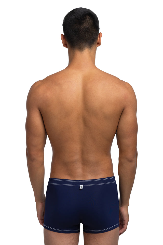 Back view of boxer briefs underwear on model in midnight blue colorway.