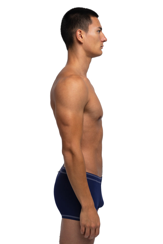 Side view of boxer briefs underwear on model in midnight blue colorway.