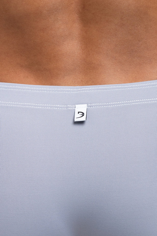 Back view of logo on boxer briefs underwear on model in slate colorway. (Close up)